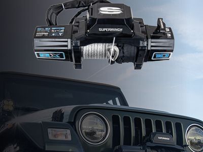 Svart vinsch av märket Superwinch som svävar ovanför en fyrhjulsdriven bil